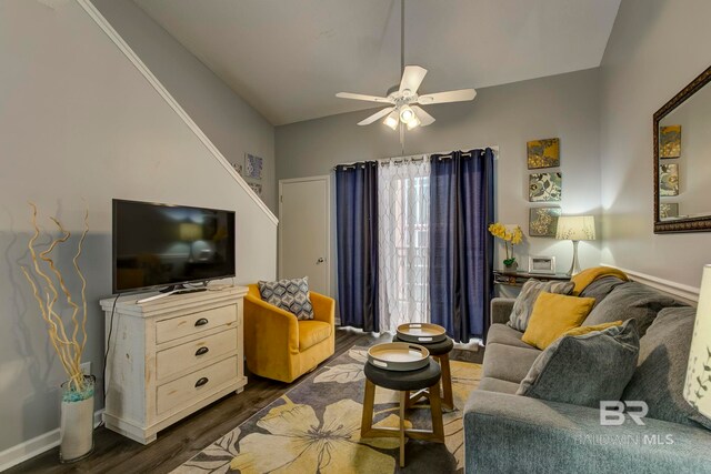 living room with ceiling fan and dark hardwood / wood-style flooring