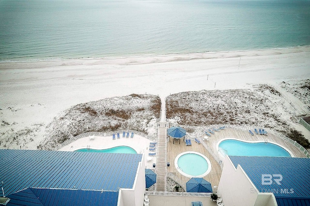 aerial view featuring a view of the beach and a water view