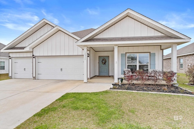 view of front of property with a garage, a front yard, board and batten siding, and concrete driveway