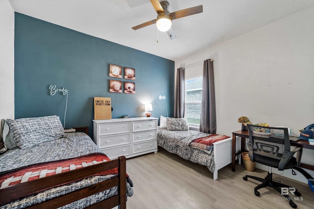 bedroom with a ceiling fan and light wood-type flooring