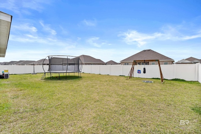 view of yard featuring a fenced backyard and a trampoline