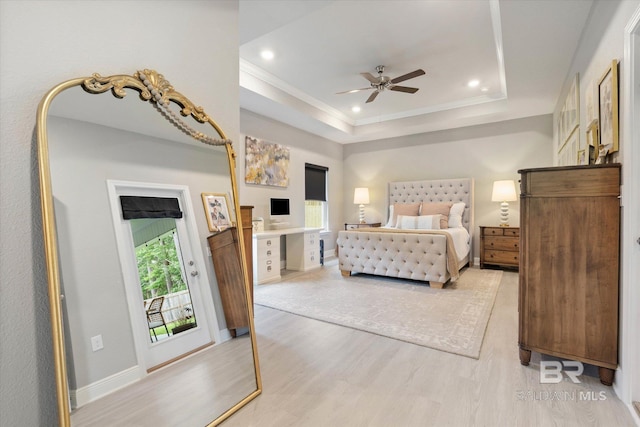 bedroom featuring wood finished floors, a tray ceiling, recessed lighting, crown molding, and baseboards