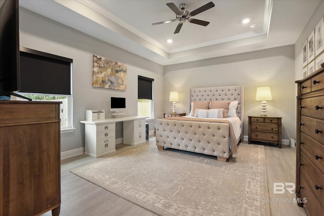 bedroom with baseboards, light wood-style flooring, a tray ceiling, crown molding, and recessed lighting