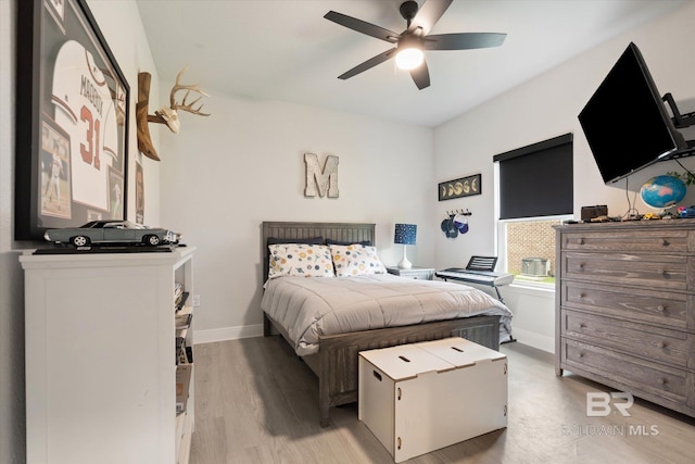 bedroom featuring baseboards, a ceiling fan, and light wood-style floors