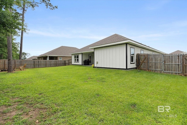 rear view of property featuring board and batten siding and a shingled roof