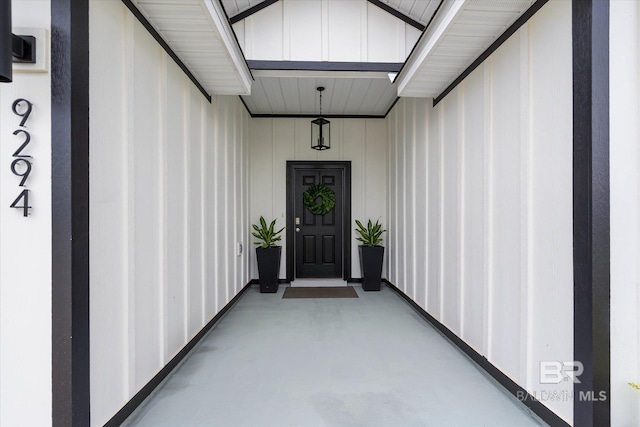view of exterior entry with board and batten siding