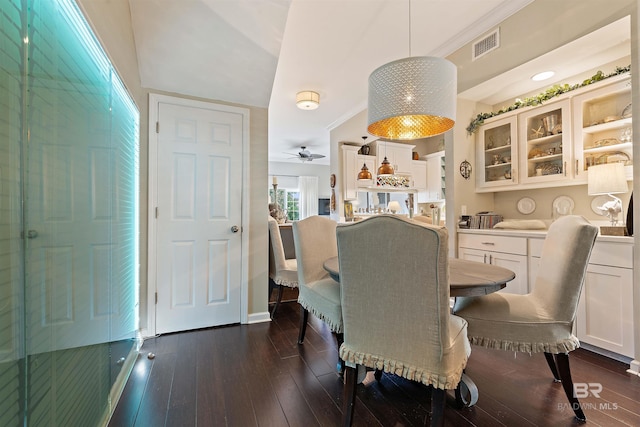 dining space with dark wood-style flooring, visible vents, and ceiling fan