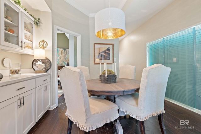 dining space featuring crown molding and dark hardwood / wood-style floors