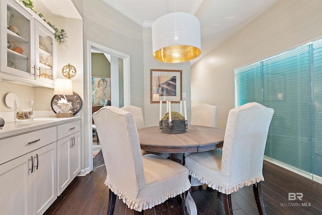 dining area featuring dark wood-style floors and ornamental molding