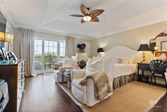 bedroom featuring a ceiling fan, dark wood-type flooring, access to exterior, a tray ceiling, and crown molding