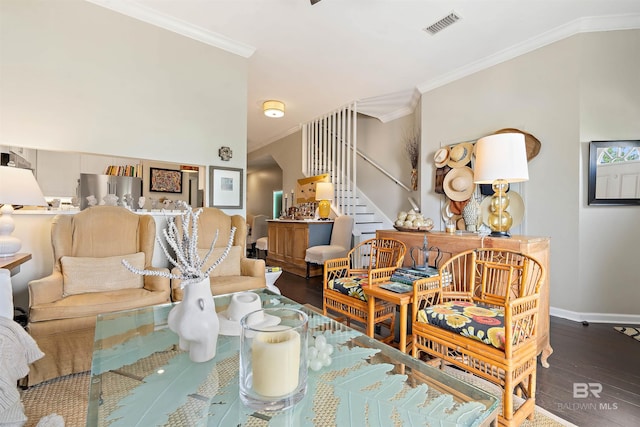 living room featuring crown molding, hardwood / wood-style flooring, and vaulted ceiling