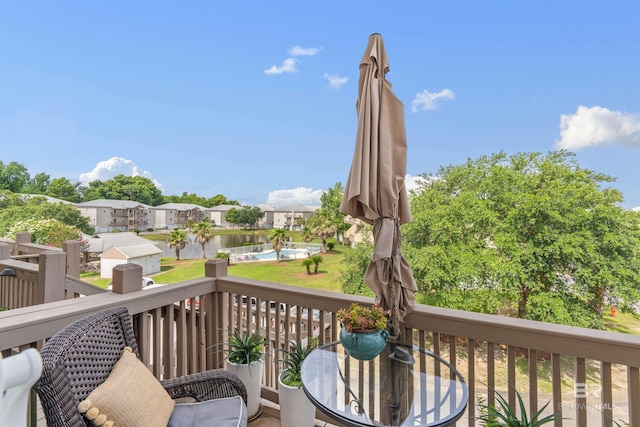 wooden deck featuring a water view and a residential view