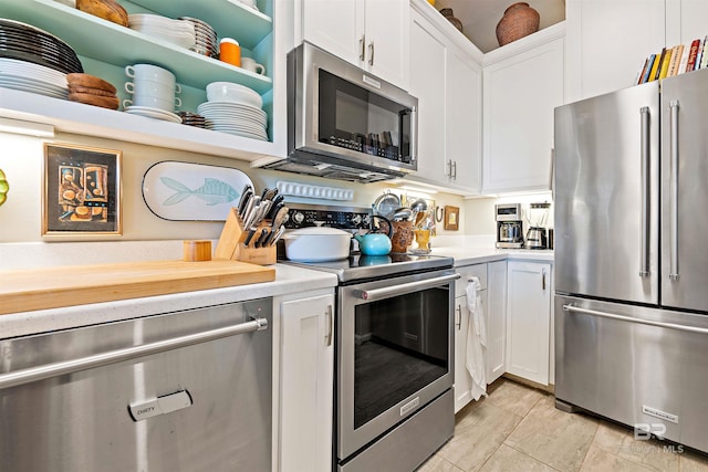 kitchen featuring stainless steel appliances, open shelves, light countertops, and white cabinets