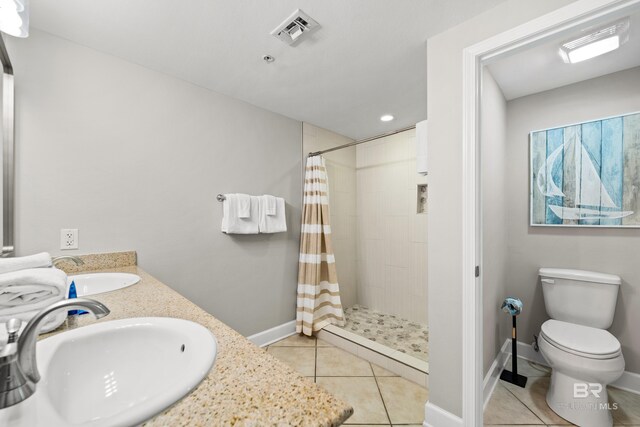 1524 W Beach Blvd Unit 506, Gulf Shores, AL 36542 - bathroom with vanity, toilet, tile patterned flooring, and a shower with shower curtain