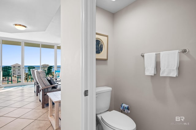 1524 W Beach Blvd Unit 506, Gulf Shores, AL 36542 - bathroom with tile patterned floors, floor to ceiling windows, and toilet