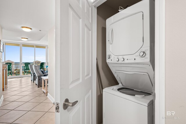 1524 W Beach Blvd Unit 506, Gulf Shores, AL 36542 - washroom with light tile patterned flooring and stacked washer / dryer