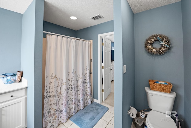 full bathroom with visible vents, toilet, a shower with curtain, tile patterned flooring, and a textured ceiling