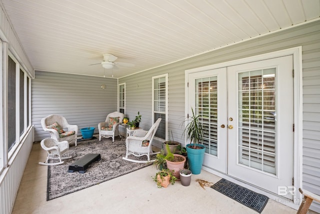 sunroom featuring a ceiling fan and french doors