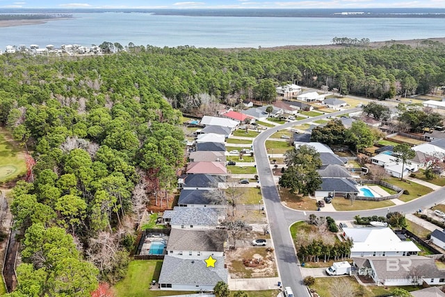 aerial view featuring a water view, a residential view, and a wooded view