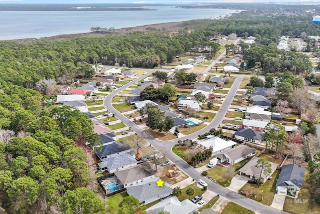 bird's eye view with a residential view, a water view, and a view of trees