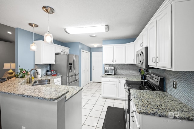 kitchen with light stone counters, light tile patterned floors, stainless steel appliances, a sink, and a peninsula