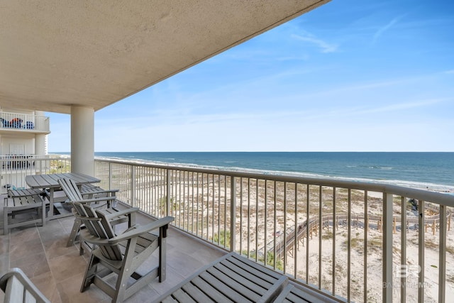 balcony with view of water and beach