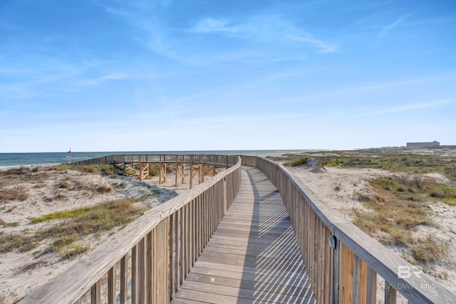 view of community featuring view of water and beach