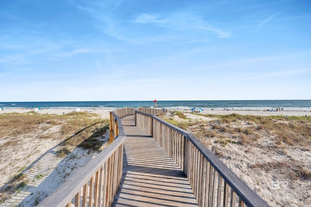 view of home's community with view of water and beach