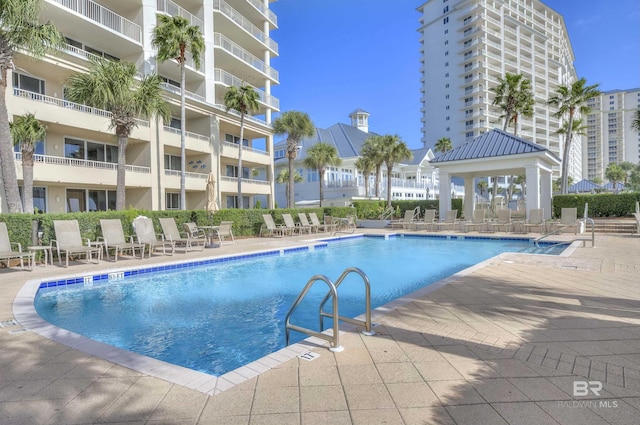 community pool featuring a gazebo and a patio