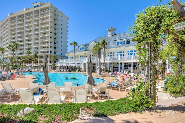 community pool with a patio area