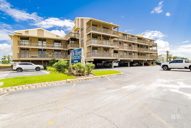 view of building exterior with uncovered parking