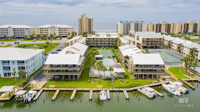 birds eye view of property featuring a water view and a city view