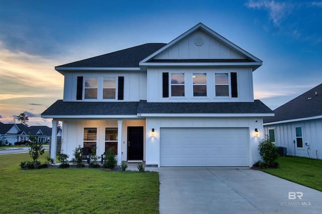 view of front of property with a garage and a lawn