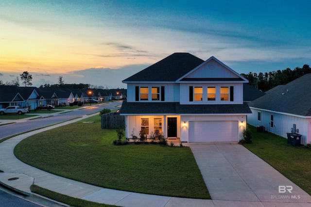 view of front facade featuring a garage and a yard