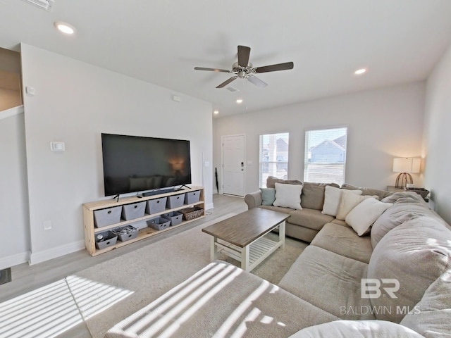 living room with light wood-type flooring and ceiling fan