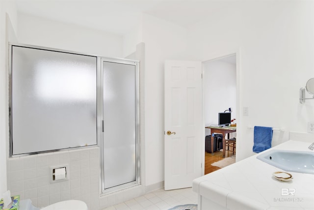 full bathroom with a shower stall and vanity