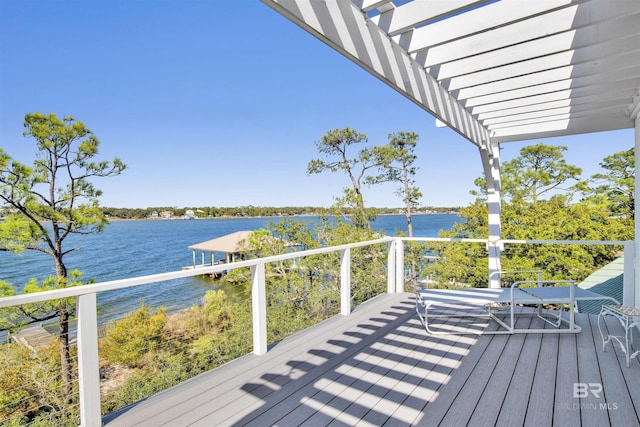 deck with a water view and a pergola