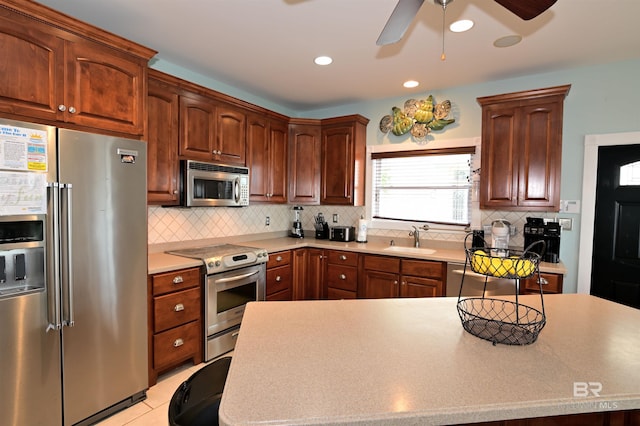 9397 S Bay Rd, Foley, AL 36535 - kitchen with light countertops, backsplash, a sink, stainless steel appliances, and ceiling fan