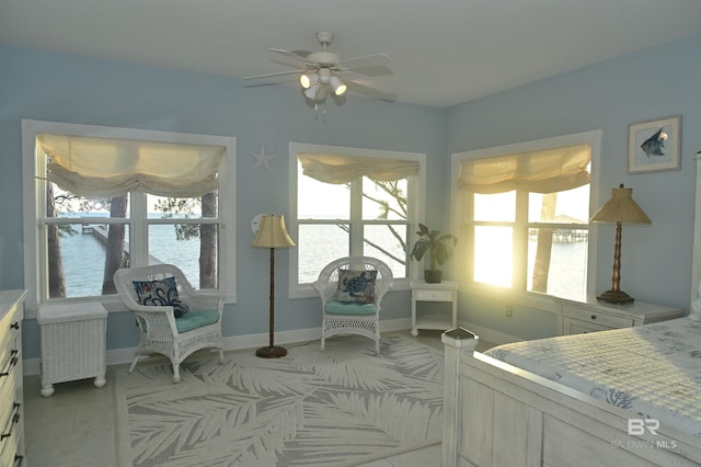 9397 S Bay Rd, Foley, AL 36535 - bedroom featuring radiator heating unit, light tile patterned floors, baseboards, and a ceiling fan