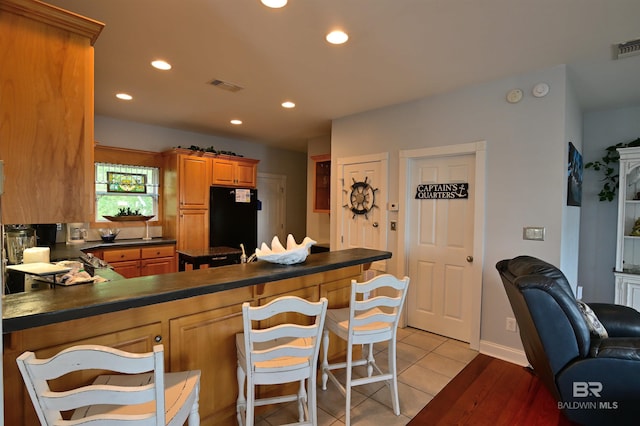 9397 S Bay Rd, Foley, AL 36535 - kitchen featuring visible vents, a peninsula, dark countertops, recessed lighting, and freestanding refrigerator