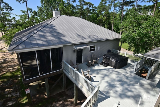 9397 S Bay Rd, Foley, AL 36535 - back of property with metal roof, a wooden deck, and a chimney