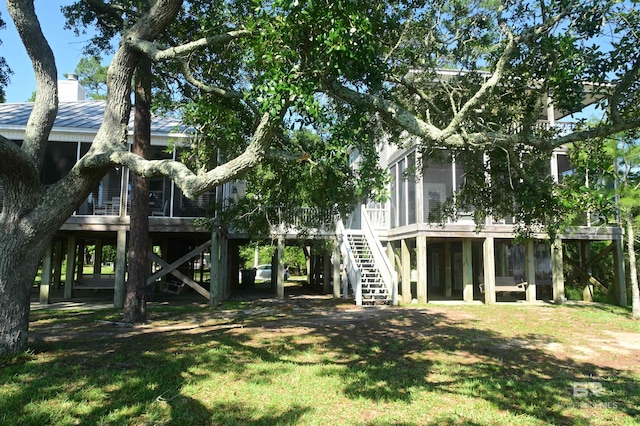 9397 S Bay Rd, Foley, AL 36535 - view of yard featuring a sunroom, stairway, and a deck