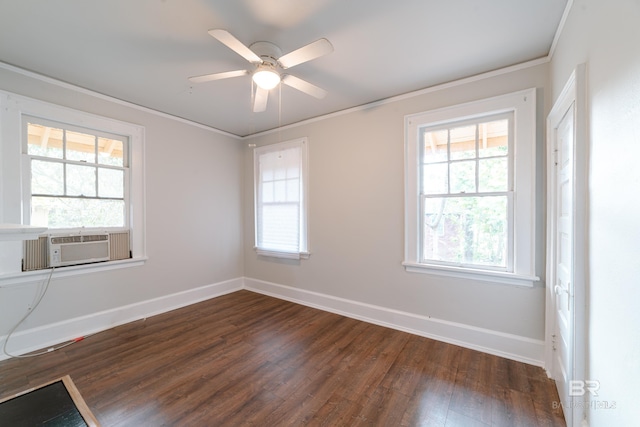 empty room featuring dark hardwood / wood-style flooring, cooling unit, ceiling fan, and a wealth of natural light