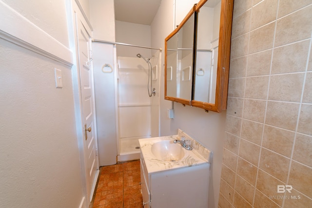 bathroom featuring vanity and a shower