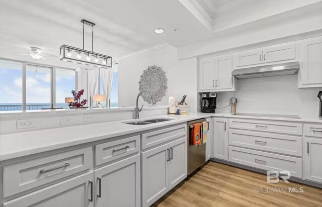 27070 Perdido Beach Blvd Unit 10W, Orange Beach, AL 36561 - kitchen with cooktop, a sink, a ceiling fan, dishwasher, and under cabinet range hood