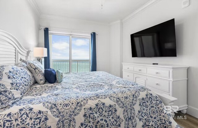 27070 Perdido Beach Blvd Unit 10W, Orange Beach, AL 36561 - bedroom featuring baseboards, crown molding, wood finished floors, and access to outside