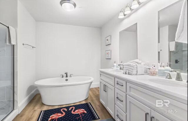27070 Perdido Beach Blvd Unit 10W, Orange Beach, AL 36561 - bathroom with a shower stall, wood finished floors, and a sink
