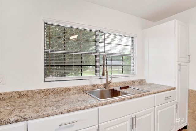 kitchen with white cabinetry, sink, and a healthy amount of sunlight