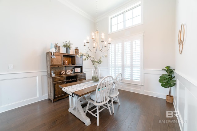 dining room with dark hardwood / wood-style flooring, ornamental molding, and a wealth of natural light