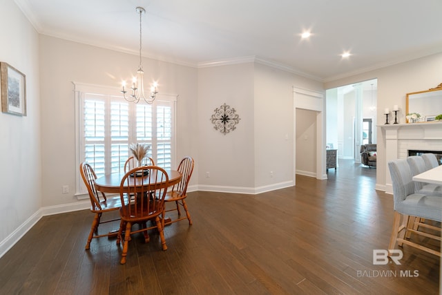 dining room featuring crown molding, a chandelier, and dark hardwood / wood-style floors